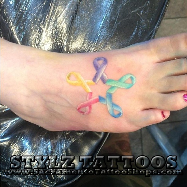 multi color watercolor foot tattoo