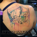 Dripping water color tattoo on back